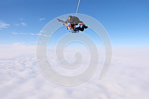 Skydiving. Tandem jump. Two skydivers are in the sky.