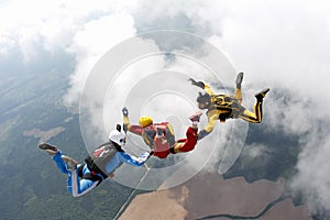 Skydiving. Two instructors are training a student to fly. photo