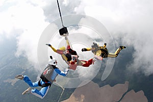 Skydiving. Two instructors are training a student to fly.