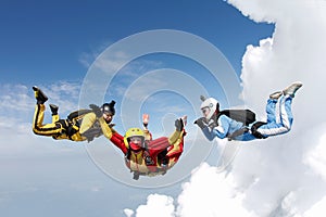 Skydiving. Two instructors are training a student to fly. photo