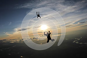 Skydiving. Two skydivers are in the sky.