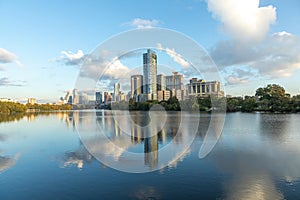 skyline of Austin in early morning light with mirroring city in the colorado river, Texas