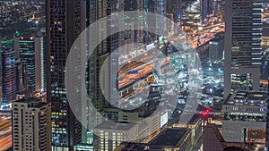 Skyline of the buildings of Sheikh Zayed Road and DIFC aerial night timelapse in Dubai, UAE.