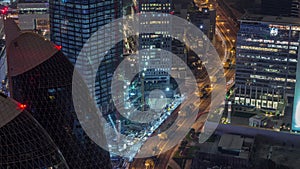 Skyline of the buildings of Sheikh Zayed Road and DIFC aerial night timelapse in Dubai, UAE.