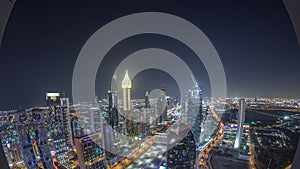 Skyline of the buildings of Sheikh Zayed Road and DIFC aerial night timelapse in Dubai, UAE.