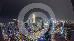 Skyline of the buildings of Sheikh Zayed Road and DIFC aerial night timelapse in Dubai, UAE.