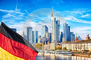 Skyline cityscape of Frankfurt, Germany during sunny day with german flag. Frankfurt Main in a financial capital of Europe