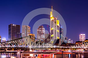 Skyline cityscape of Frankfurt, Germany during twilight evening with a bridge. Frankfurt Main in a financial capital of Europe