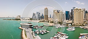 The skyline of Doha, Qatar. Modern rich middle eastern city of skyscrapers, aerial view of marina and beach of Persian gulf.