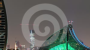 Skyline of Dubai at night timelapse with Burj al Arab in foreground in Dubai, United Arab Emirates