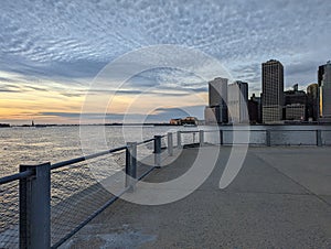 Skyline of financial district in New York City with modern office buildings seen from pier