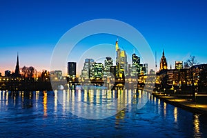 Skyline of Frankfurt, Germany in the sunset with famous illuminated skyscrapers