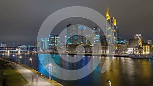 Skyline of Frankfurt am Main by night with colorful reflection in the river,