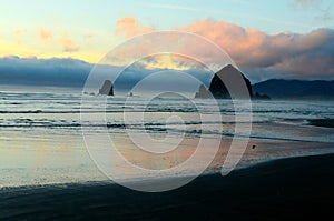 Skyline of Haystack rock at the Cannon beach captured against the cloudy sunset sky