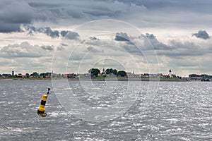 Skyline historic Dutch fishing village Urk covered with cloudy sky