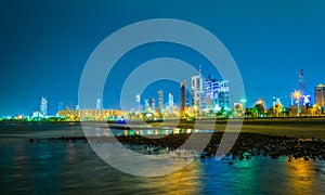 Skyline of Kuwait including the Seif palace, Liberation tower and the National assembly building during night....IMAGE