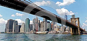 Skyline of Manhattan and brooklyn bridge viewed from a boat on East River, New York City