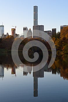 Skyline of Manhattan reflected in a pond in central park at sunrise