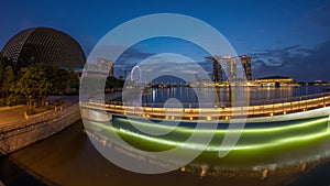 Skyline in Marina Bay with Esplanade Theaters on the Bay and Esplanade footbridge night to day timelapse in Singapore.