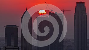 Skyline with modern architecture of Dubai business bay towers at sunset timelapse. Aerial view