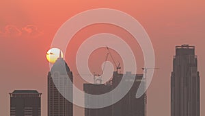 Skyline with modern architecture of Dubai business bay towers at sunset timelapse. Aerial view