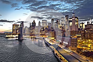 Skyline of New York City downtown and Brooklyn bridge dusk view