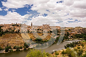 Skyline of the old city of Toledo on the hill where the Old Cathedral and the Alcazar stand embraced by the Tagus River