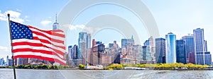 Skyline panorama of downtown Financial District and the Lower Manhattan in New York City with american flag, USA