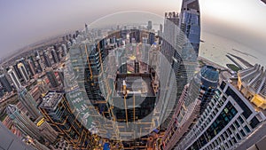 Skyline panorama of Dubai Marina showing canal surrounded by skyscrapers along shoreline day to night . DUBAI, UAE