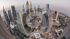 Skyline panorama of the high-rise buildings on Sheikh Zayed Road in Dubai aerial day to night timelapse, UAE.