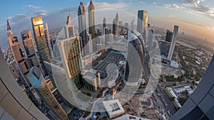 Skyline panorama of the high-rise buildings on Sheikh Zayed Road in Dubai aerial night to day timelapse, UAE.