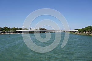 Skyline with Pasarela de la Cartuja over Guadalquivir river in Seville City. Spain.