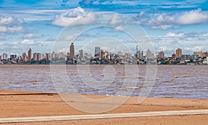 Skyline of Posadas in Argentina, photographed from the beach in Encarnacion.