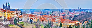 The skyline of Prague with St Vitus Cathedral and red tile roofs, Czech Republic