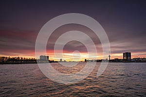 The skyline of Rotterdam at night. Maas canal on the foreground, sunset with nice sky, Rotterdam, THe Netherlands