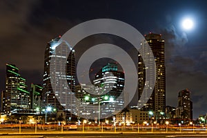 Skyline of San Diego with big moon behind the skys