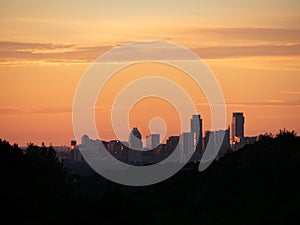 Skyline shot of Austin Texas downtown nestled between silhouetted hills