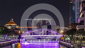 Skyline of Singapore financial district behind Elgin Bridge and the Singapore River night timelapse hyperlapse