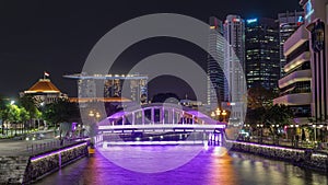 Skyline of Singapore financial district behind Elgin Bridge and the Singapore River night timelapse hyperlapse