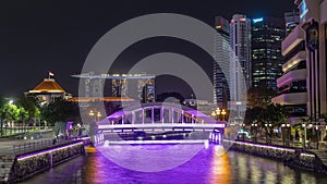 Skyline of Singapore financial district behind Elgin Bridge and the Singapore River night timelapse hyperlapse