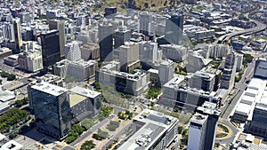 Skyline, sky scraper and city buildings with drone, cityscape and traffic in highway, infrastructure and cape town