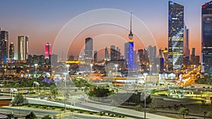 Skyline with Skyscrapers day to night timelapse in Kuwait City downtown illuminated at dusk. Kuwait City, Middle East