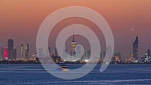 Skyline with Skyscrapers day to night timelapse in Kuwait City downtown illuminated at dusk. Kuwait City, Middle East