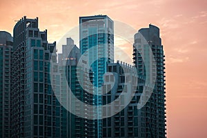 Skyline, skyscrapers in Dubai. Many tall buildings at sunset, silhouettes of skyscrapers