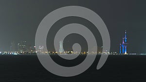 Skyline with Skyscrapers night timelapse in Kuwait City downtown illuminated at dusk. Kuwait City, Middle East