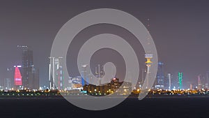 Skyline with Skyscrapers night timelapse in Kuwait City downtown illuminated at dusk. Kuwait City, Middle East