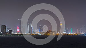 Skyline with Skyscrapers night timelapse in Kuwait City downtown illuminated at dusk. Kuwait City, Middle East