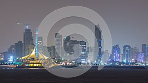 Skyline with Skyscrapers night timelapse in Kuwait City downtown illuminated at dusk. Kuwait City, Middle East