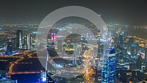 Skyline with Skyscrapers night timelapse in Kuwait City downtown illuminated at dusk. Kuwait City, Middle East