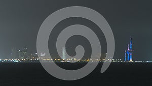 Skyline with Skyscrapers night timelapse in Kuwait City downtown illuminated at dusk. Kuwait City, Middle East